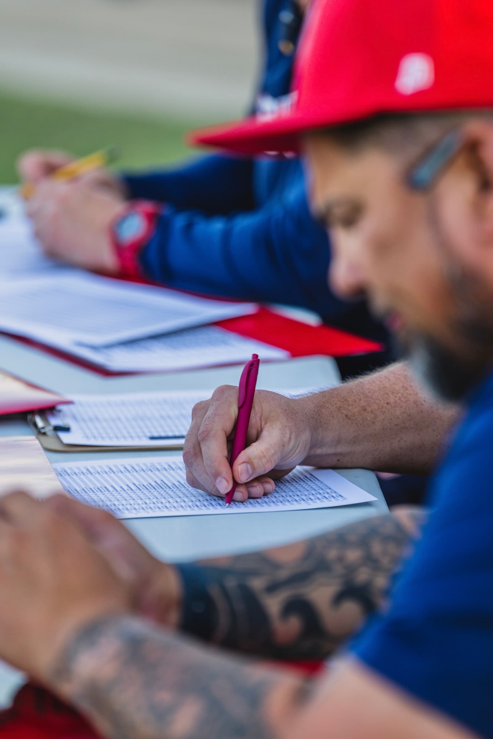 Coaches writing detailed tryout evaluation notes